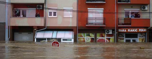 People look out from their apartments as they wait to be evacuated in the town of Obrenovac, east from Belgrade